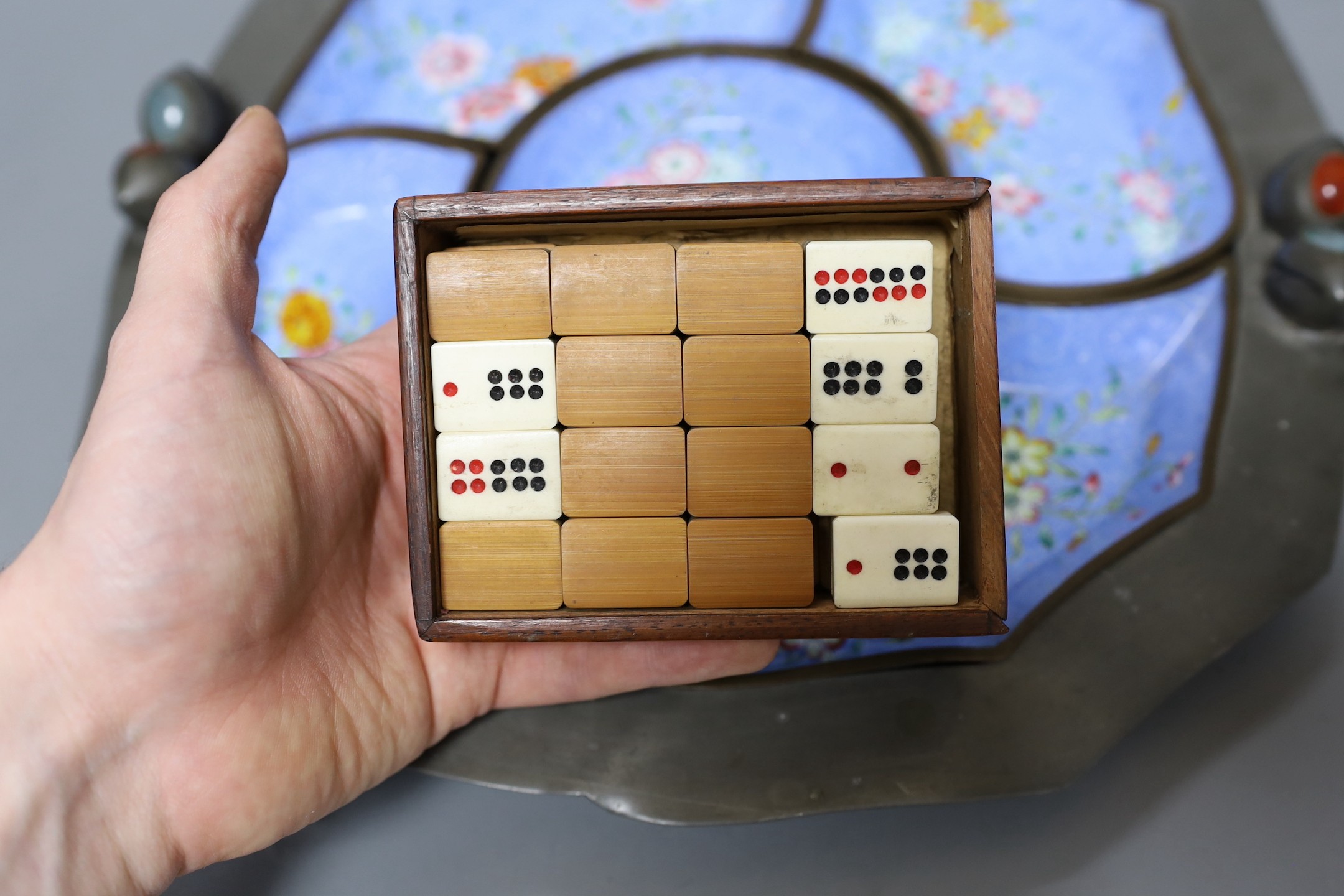 An early 20th century Chinese Guangzhou enamel supper set in a pewter tray, 35cm and a boxed set of bamboo and bone dominoes